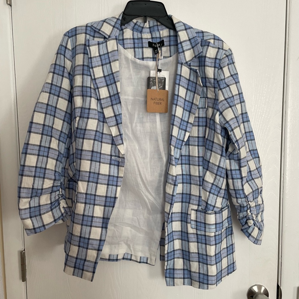 Woman’s blue and white plaid blazer